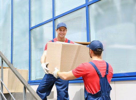 Van moving crew reviewing safety measures before lifting items