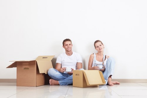 Business movers packing office equipment for relocation
